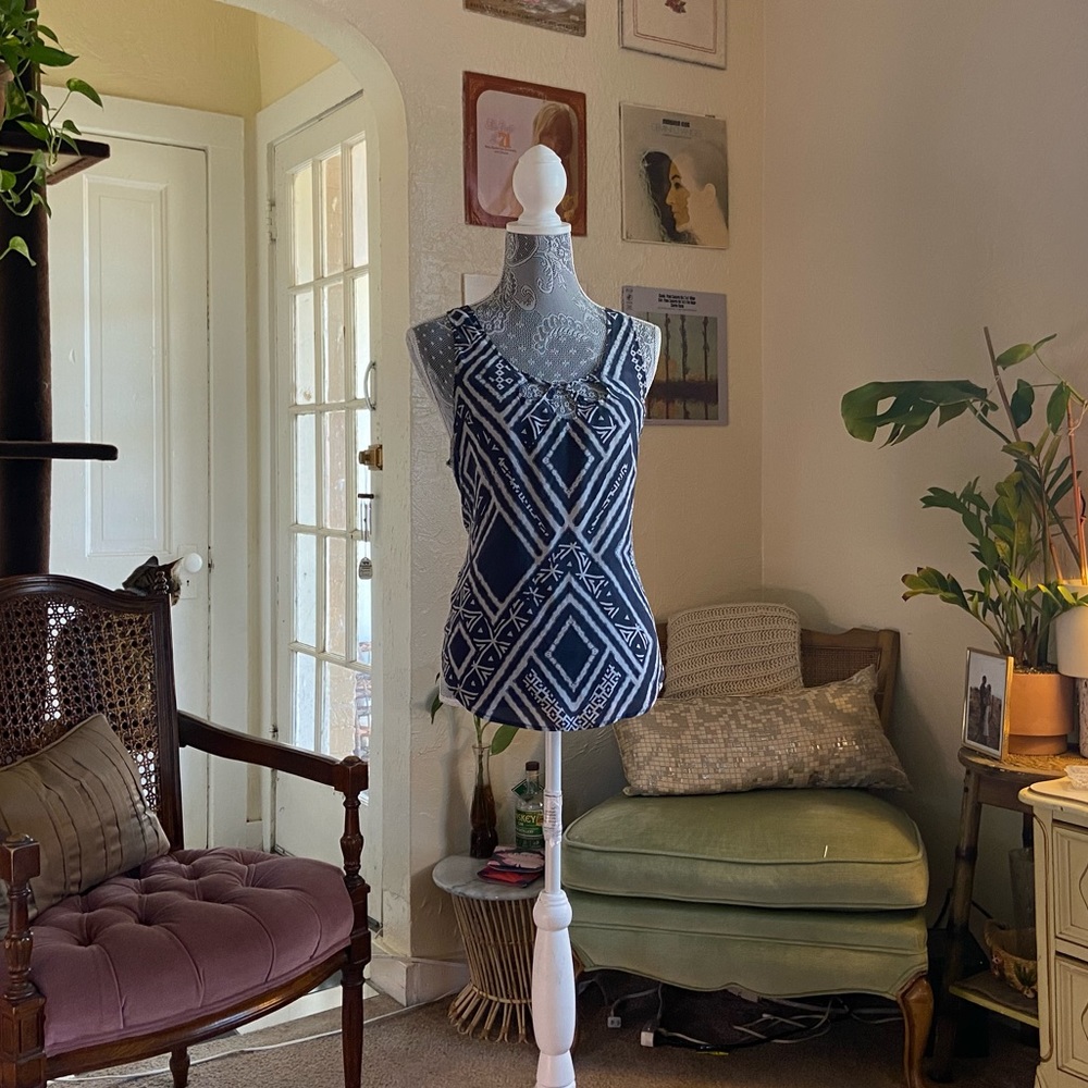 Ecotè blue and white patterned blouse with crisscross laces on the back.